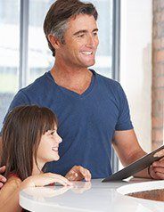 Man and daughter at front desk