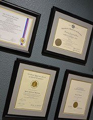 Certifications hanging on wall