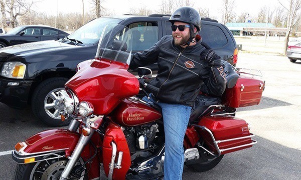 Team member posing on motorcycle