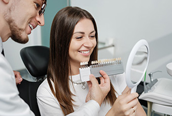 woman smiling looking at veneer options