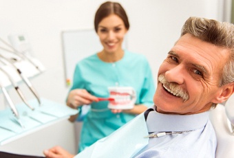 Patient with dentures in Ripon smiling with dentist