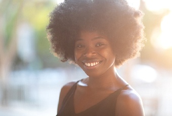 person smiling while taking a walk outside