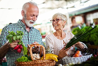 Happy senior couple shopping for vegetables