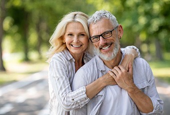 Happy older couple posing outdoors