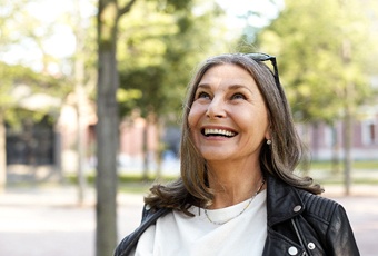 Happy woman with implant denture in Ripon, WI