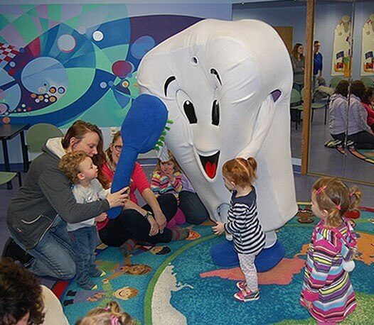 Kids playing with Pearl E. White