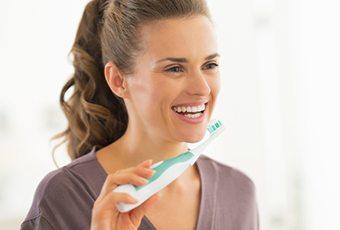 Smiling woman holding toothbrush