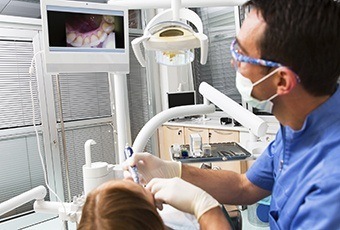 Patient and dentist looking at dental images