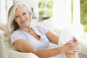 woman smiling on a sunlit porch