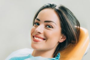 Woman smiling in dentist's chair.