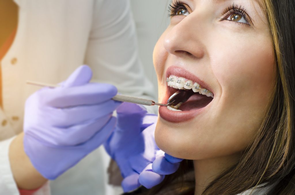 Woman with braces getting a checkup