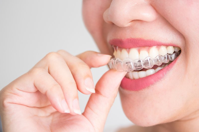 an Invisalign aligner in a person’s mouth