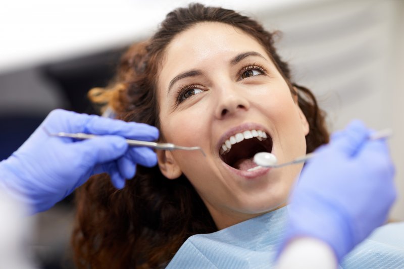 Brown-haired woman about to receive dental cleaning