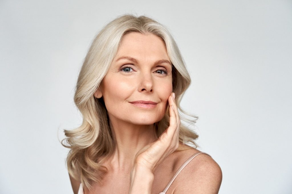 Woman in her 50s smiling after getting BOTOX®