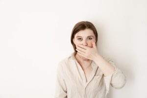 Concerned person covering their mouth